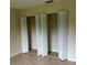 Bedroom closet with bi-fold doors and shelving in a room with tile flooring at 15 Clear Way, Ocala, FL 34472