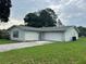 One-story single-Gathering home with a light green exterior, white trim, and a one-car garage at 15 Clear Way, Ocala, FL 34472