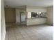 Open-concept living area with tile flooring, a kitchen breakfast bar, and neutral paint at 15 Clear Way, Ocala, FL 34472