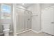 A modern bathroom showcasing a glass-enclosed shower with tiled walls and flooring at 150 Marion Oaks Golf Rd, Ocala, FL 34473