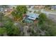 Aerial view of a home showcasing a screened pool, backyard playground, and lush trees at 15052 Sw 43Rd Terrace Rd, Ocala, FL 34473