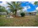 Backyard view with a screened-in pool, patio area, and lush landscaping at 15052 Sw 43Rd Terrace Rd, Ocala, FL 34473