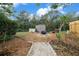 Private backyard with a fire pit, shed, and seating area, creating an inviting outdoor gathering space at 15052 Sw 43Rd Terrace Rd, Ocala, FL 34473