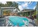 Inviting screened-in pool area features comfortable seating and lush landscaping for relaxing outdoors at 15052 Sw 43Rd Terrace Rd, Ocala, FL 34473