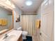 Bathroom featuring a round skylight, a single sink vanity, a white toilet and a shower with curtain at 15857 Sw 11Th Terrace Rd, Ocala, FL 34473