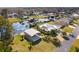 Aerial view of a waterfront home, showcasing lush landscaping, detached garages, and serene water access at 1621 Yellow Brick Rd, Astor, FL 32102