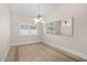 Bright dining room with decorative tile flooring, a large window, and mirrored wall accents at 1621 Yellow Brick Rd, Astor, FL 32102