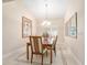 Bright dining area featuring modern chandelier, decorative wall art, and tiled flooring at 1621 Yellow Brick Rd, Astor, FL 32102