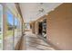 Spacious sunroom with tile floors, ceiling fans, and large windows showcasing the lawn at 1621 Yellow Brick Rd, Astor, FL 32102