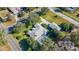 An aerial view of a home with a screened pool, a large front yard, and a two-car garage in a suburban neighborhood at 1712 Ne 40Th Ave, Ocala, FL 34470