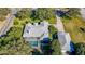 Birds-eye view of a beautiful home featuring a large screened-in pool, mature landscaping, and a detached garage at 1712 Ne 40Th Ave, Ocala, FL 34470
