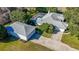 Aerial view of gray roof home with separate garage, driveway and screened pool at 1712 Ne 40Th Ave, Ocala, FL 34470