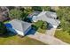 Lovely home with a screened pool, large driveway, and detached two-car garage with a mature landscaped lawn at 1712 Ne 40Th Ave, Ocala, FL 34470
