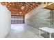 Large basement with exposed ceiling beams, perfect for storage or workshop space at 1712 Ne 40Th Ave, Ocala, FL 34470