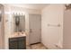 Bathroom features a vanity sink, mirror, and medicine cabinet near the entry door at 1712 Ne 40Th Ave, Ocala, FL 34470