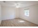 Bright bedroom with ceiling fan, window, and light wood-look flooring at 1712 Ne 40Th Ave, Ocala, FL 34470