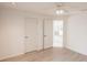 Neutral bedroom showing an open doorway to the kitchen and light wood flooring at 1712 Ne 40Th Ave, Ocala, FL 34470