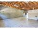 Wide open garage space with concrete block wall, workbench, and exposed rafter ceiling at 1712 Ne 40Th Ave, Ocala, FL 34470