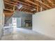 Cement floor garage with back entry door, workbench, and exposed rafter ceiling at 1712 Ne 40Th Ave, Ocala, FL 34470