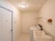 Laundry room with utility sink and machines at 1712 Ne 40Th Ave, Ocala, FL 34470