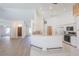 Open floor plan with wood floors, breakfast bar, and a view of the kitchen area and front door at 1712 Ne 40Th Ave, Ocala, FL 34470