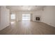Spacious living room featuring wood floors, a cozy fireplace, and sliding glass doors to the pool at 1712 Ne 40Th Ave, Ocala, FL 34470