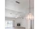 Living room area with a chandelier, fireplace, ceiling fan and sliding glass doors leading to the pool at 1712 Ne 40Th Ave, Ocala, FL 34470