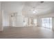Bright living room with wood floors, open layout, ceiling fan, and sliding doors to the pool area at 1712 Ne 40Th Ave, Ocala, FL 34470
