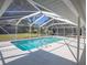 Screened in pool surrounded by patio and views of the backyard at 1712 Ne 40Th Ave, Ocala, FL 34470