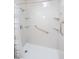 Bathroom shower is equipped with accessibility features and built-in shelves at 1712 Ne 40Th Ave, Ocala, FL 34470