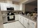 Bright kitchen with stainless steel appliances and white cabinets at 2857 Sw 32Nd Ave, Ocala, FL 34474