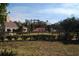 View of the backyard fence and the adjacent neighbor's house with mature landscaping at 3560 Sw 24Th Avenue Rd, Ocala, FL 34471