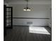 Bright dining room with wood floors, modern chandelier, chair rail, and view of the window at 3560 Sw 24Th Avenue Rd, Ocala, FL 34471