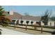 Exterior of the home with a brick facade, dark awnings, and a wooden fence in the front at 3560 Sw 24Th Avenue Rd, Ocala, FL 34471