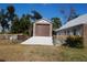 Two-story garage featuring brick exterior, concrete driveway, and second-floor storage at 3560 Sw 24Th Avenue Rd, Ocala, FL 34471