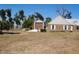 Detached two-story garage featuring brown door, and a concrete driveway at 3560 Sw 24Th Avenue Rd, Ocala, FL 34471