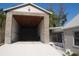 Two-story garage featuring brick exterior, open garage door and concrete driveway at 3560 Sw 24Th Avenue Rd, Ocala, FL 34471