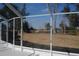 View of the spacious yard from the screened enclosure that features a white frame and a view of the yard at 3560 Sw 24Th Avenue Rd, Ocala, FL 34471