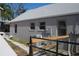 Exterior view of home featuring a gray exterior, white trim, and mature landscaping at 3560 Sw 24Th Avenue Rd, Ocala, FL 34471