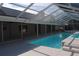 Swimming pool with a screened enclosure and attached covered patio area, perfect for relaxation and enjoyment at 3560 Sw 24Th Avenue Rd, Ocala, FL 34471