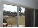 Sliding glass door showcases the large front yard and serene neighborhood view at 3560 Sw 24Th Avenue Rd, Ocala, FL 34471