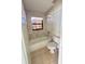 Bathroom featuring a tub with tile surround, a window, and a toilet at 3940 Sw 138Th Pl, Ocala, FL 34473