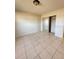 Bedroom with tile flooring and sliding closet doors at 3940 Sw 138Th Pl, Ocala, FL 34473