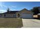 Charming single-story home with a two-car garage and well-maintained front yard at 3940 Sw 138Th Pl, Ocala, FL 34473