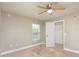 Small carpeted bedroom with a ceiling fan, a window, and a walk-in closet at 4604 Se 33Rd Pl, Ocala, FL 34480