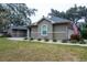 The side of the home features neutral stucco and decorative landscaping that adds to the property's curb appeal at 4604 Se 33Rd Pl, Ocala, FL 34480