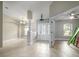 Bright foyer with tile floors, decorative column, chandelier, and front door with glass inserts at 4604 Se 33Rd Pl, Ocala, FL 34480