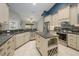 Modern kitchen featuring granite countertops, stainless steel appliances, an island, and custom cabinetry at 4604 Se 33Rd Pl, Ocala, FL 34480