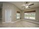 Bright living room with tile floors, large windows overlooking the pool area and a ceiling fan at 4604 Se 33Rd Pl, Ocala, FL 34480