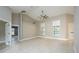 Expansive living room with neutral tile flooring, high ceilings, and abundant natural light from windows at 4604 Se 33Rd Pl, Ocala, FL 34480